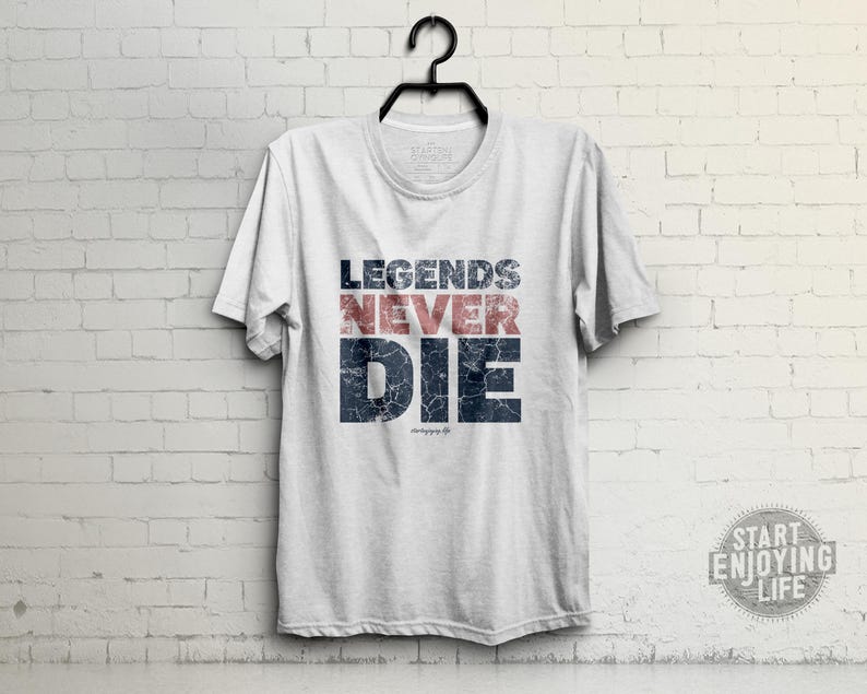 May include: White t-shirt with a blue and red distressed graphic that says "Legends Never Die".