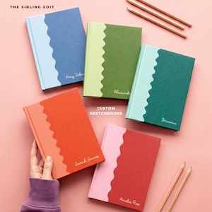 May include: Five hardcover sketchbooks with a wavy color-blocked design on the front covers. Each book features a custom name in white script. The colors include blue, green, orange, and pink combinations. Three wooden pencils are included.