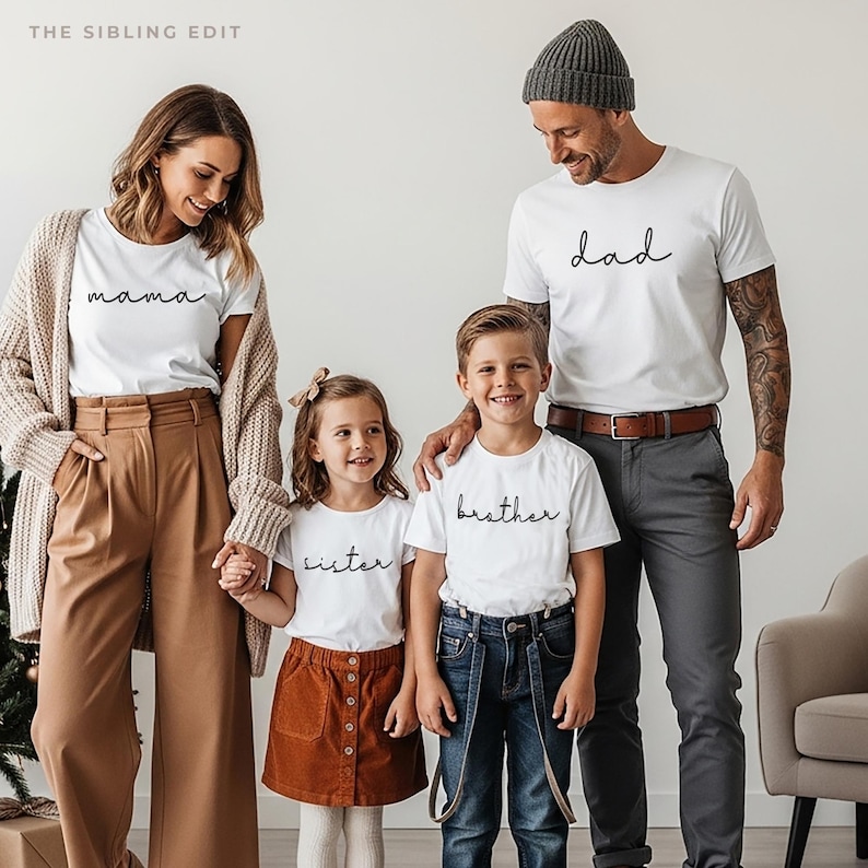 May include: A family of five wearing matching white t-shirts with black script. The shirts read "mama", "dad", "sister", and "brother". The adults wear neutral-colored pants and a cardigan. The children wear a corduroy skirt and jeans.