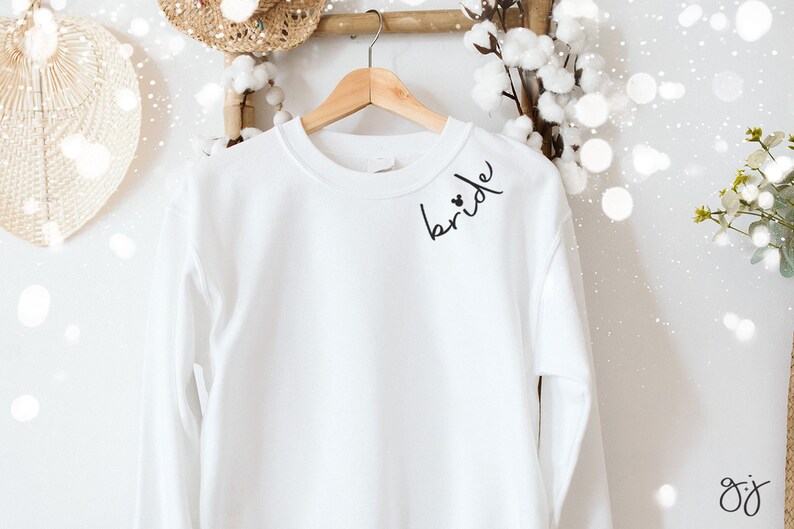 May include: A handmade wooden sign with the word "Welcome" in a whimsical font. It has a distressed white background and a dark brown border, suitable for a front door or hallway.