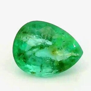 May include: A pear-shaped, vibrant green emerald gemstone. The gem has a polished surface with internal inclusions, and a bright, translucent appearance. The emerald is set against a plain white background.