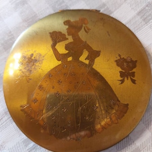 Makeup.  Brass powder compact