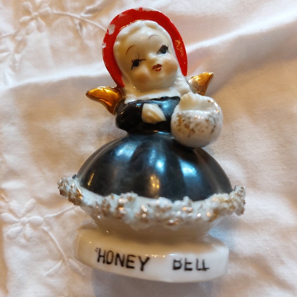 Vintage spaghetti trim angel Honey Bell figurine.