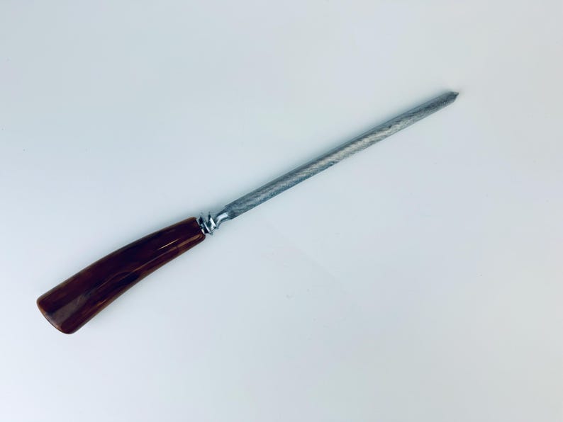 May include: A brown and silver steel knife sharpener with a wooden handle.