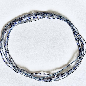 May include: A multi-strand beaded necklace with blue, silver, and clear beads.