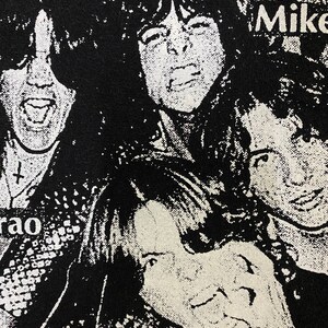 May include: Black and white image of four people with long hair. The image is a close-up of their faces. The text "Mike" is visible in the upper right corner of the image.