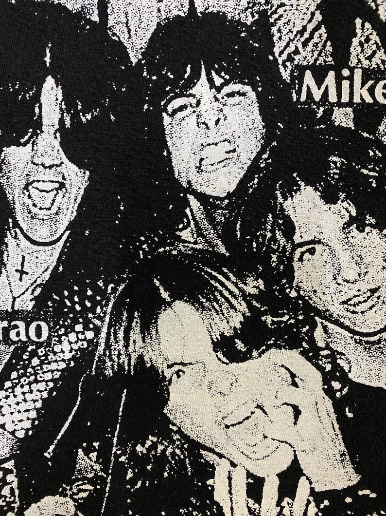 May include: Black and white image of four people with long hair. The image is a close-up of their faces. The text "Mike" is visible in the upper right corner of the image.