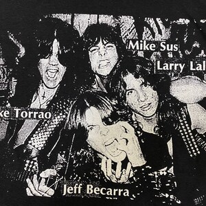 May include: Black and white photo of a band, with the names "Mike Torrao", "Mike Sus", "Larry Lalonde", and "Jeff Becarra" printed on the image.
