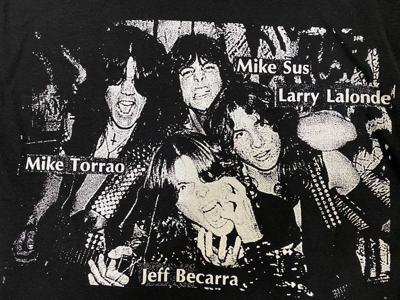 May include: Black and white photo of a band, with the names "Mike Torrao", "Mike Sus", "Larry Lalonde", and "Jeff Becarra" printed on the image.