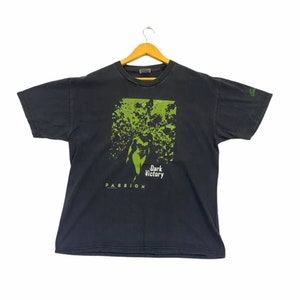 May include: Black t-shirt with a green graphic print of a woman in a forest with the text "Dark Victory" and "Passion" below.