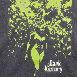 May include: Black t-shirt with a green and black graphic of a woman with the text "Dark Victory" and "Passion" below. The text "TM & &copy; 2000 DC COMICS" is at the bottom.