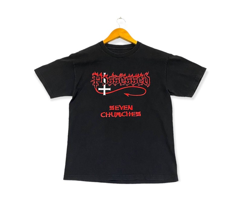 May include: Black t-shirt with a red graphic of a flaming upside-down cross and the text "Possessed Seven Churches".