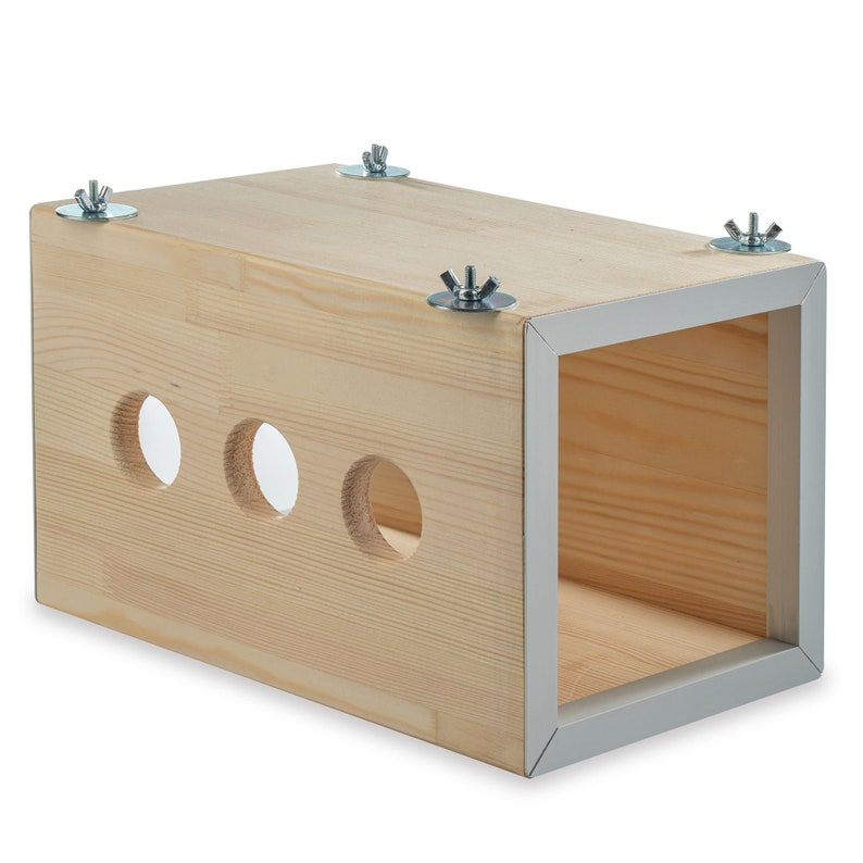 May include: A wooden box with three holes and a grey trim. The box is held together with four silver screws.