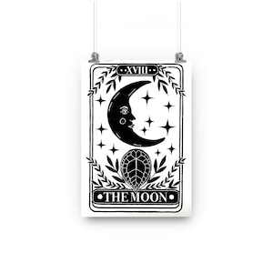 May include: Black and white tarot card illustration of The Moon card. The card features a crescent moon with a face, stars, and a leaf design. The text "XVIII" and "THE MOON" are printed on the card.