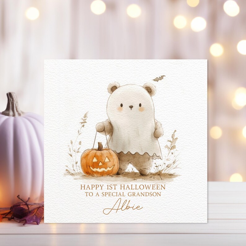 May include: A white bear wearing a ghost costume holds a jack-o'-lantern. The card reads "Happy 1st Halloween to a special grandson Albie".