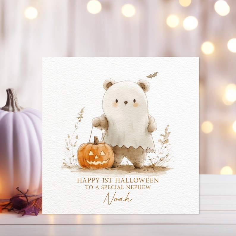 May include: A white bear wearing a ghost costume holds a jack-o'-lantern. The card reads "Happy 1st Halloween to a special nephew Noah".
