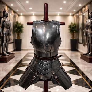 May include: A polished steel breastplate and skirt armor, displayed on a wooden stand. The armor features a brown leather belt and straps with buckles. The background shows a hallway with two full suits of armor and decorative plants.