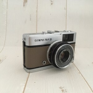Contrail Film Camera - Left-side view of Olympus Trip 35 film camera with fawn leather covering