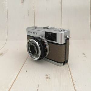 Contrail Film Camera - Angled right-side view of fawn leather Olympus Trip 35, vintage 35mm camera