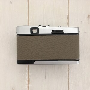 Contrail Film Camera - Back view of Olympus Trip 35 camera with fawn leather, showing controls and texture