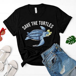 May include: Black t-shirt with white text that says "Save the Turtles" and a graphic of a leatherback sea turtle with a plastic bag caught in its mouth.