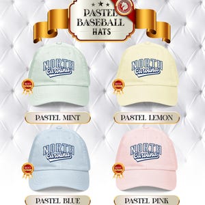 May include: Four pastel baseball caps in mint, lemon, blue, and pink. Each cap displays "North Carolina" in a script font. The hats are presented against a white, quilted backdrop.