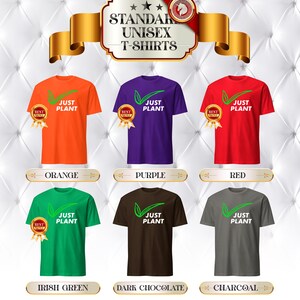May include: A display of six standard unisex t-shirts in various colors: orange, purple, red, Irish green, dark chocolate, and charcoal. Each shirt features the text "JUST PLANT" with a green leaf design. The shirts are labeled with their respective colors.