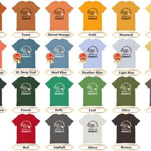 May include: A collection of 18 t-shirts in various colors, each featuring a graphic of a hand holding a box of spaghetti and the text "Light on the Streets, I Spread the Spaghetti".