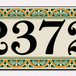 May include: A rectangular house number plaque displaying the black digits 2372 on a cream background. The border features a repeating pattern of green and orange semi-circles with white fan-like details. Two silver screws are visible on the sides.