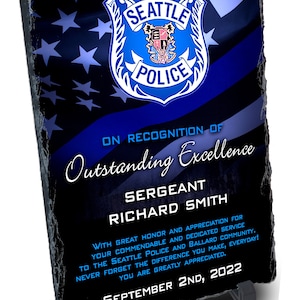 May include: A black slate plaque with a blue and white Seattle Police Department badge, a thin blue line, and stars. The plaque reads "On Recognition of Outstanding Excellence Sergeant Richard Smith With great honor and appreciation for your commendable and dedicated service to the Seattle Police and Ballard community. Never forget the difference you make, everyday! You are greatly appreciated. September 2nd, 2022"
