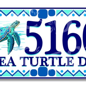 May include: A white ceramic house number sign with a blue border and a turquoise and blue geometric pattern. The number 5160 is displayed in blue with a sea turtle illustration. The text "SEA TURTLE DR" is displayed in blue below the number.