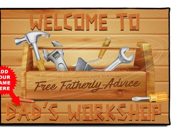 May include: A brown wooden doormat with the text "Welcome to Dad's Workshop" and a toolbox with tools inside. The toolbox has the text "Free Fatherly Advice" on it.
