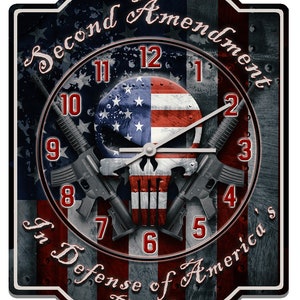 May include: A clock with a skull and crossbones design, featuring an American flag background. The clock face reads "Second Amendment" and "In Defense of America's Freedom".