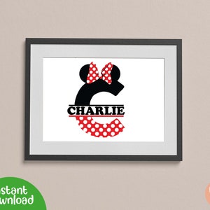 May include: A black and white letter C with red and white polka dots. The letter C has a red bow and black mouse ears on top. The name "CHARLIE" is written in black across the middle of the letter.