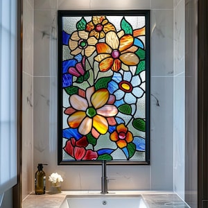 May include: A rectangular stained glass window in a black frame. The window displays a colourful floral design with yellow, orange, blue, and red flowers. Green leaves and stems are also present, creating a vibrant and decorative piece.