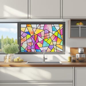 May include: A kitchen window featuring a colourful stained glass window film. The film is made up of geometric shapes in shades of pink, purple, yellow, blue and green.