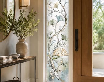 May include: A vertical rectangular window film featuring a frosted glass texture with a printed design of climbing ginkgo branches in shades of blue, green, and gold. The pattern includes stylized leaves and a semi-circular sun motif at the base.