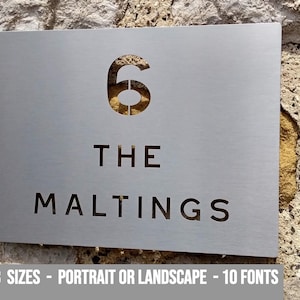 May include: A silver metal house number sign with the number 6 and the text "The Maltings" cut out.