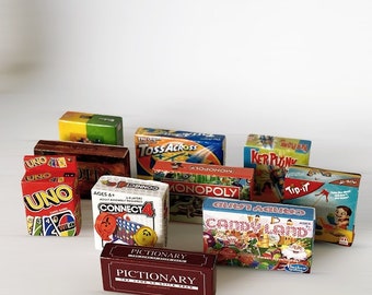 May include: A collection of miniature board game boxes, including classics like Monopoly, Candy Land, and Connect 4. The boxes are colorful and feature various illustrations and logos.