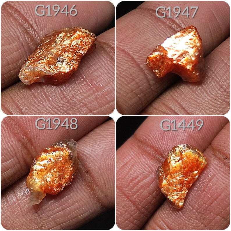 May include: Four rough, orange-brown sunstone crystals with a metallic sheen. The crystals are labeled G1946, G1947, G1948, and G1449.