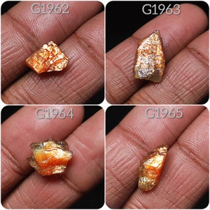 May include: Four pieces of raw, orange and gold sunstone, labeled G1962, G1963, G1964, and G1965.