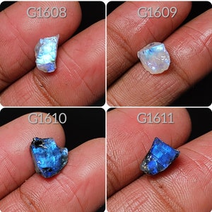 May include: Four rough, natural gemstone cabochons, each with a different color and iridescent sheen. The top left is white with blue iridescence, the top right is white with blue iridescence, the bottom left is blue with green iridescence, and the bottom right is blue with green iridescence. The stones are labeled G1608, G1609, G1610, and G1611.