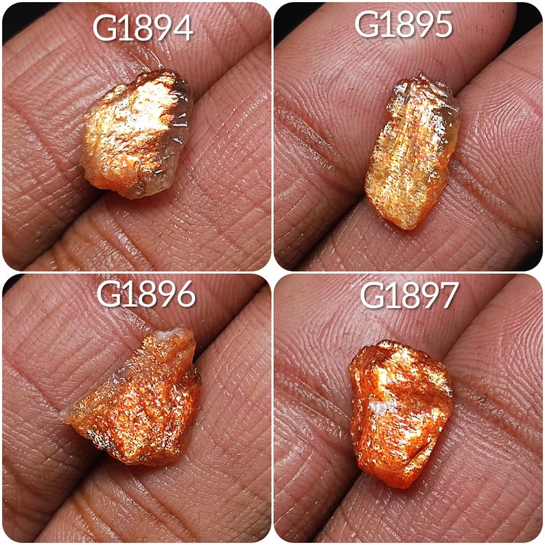 May include: Four sunstone specimens, each with a unique shape and color variation. The stones are a mix of orange, red, and gold, with a shimmering, iridescent effect. The stones are labeled with the numbers G1894, G1895, G1896, and G1897.