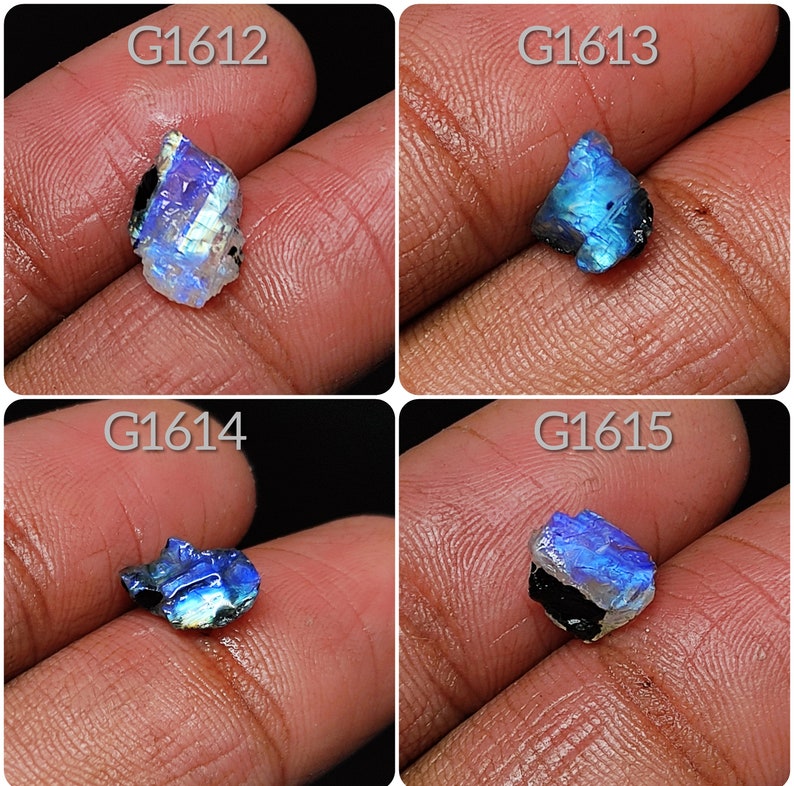 May include: Four iridescent blue labradorite gemstones with black inclusions. The stones are labeled G1612, G1613, G1614, and G1615.