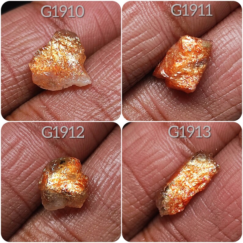May include: Four pieces of raw, rough, orange and gold sunstone crystals with iridescent shimmer. The crystals are labeled G1910, G1911, G1912, and G1913.