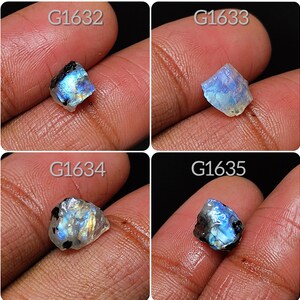 May include: Four rough, iridescent moonstone gemstones, each with a unique shape and color, labeled G1632, G1633, G1634, and G1635.