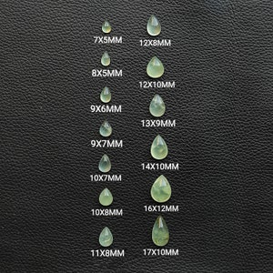 May include: A set of 10 teardrop-shaped green gemstones of varying sizes, arranged in two columns. The gemstones are labeled with their dimensions in millimeters, ranging from 7x5mm to 17x10mm.