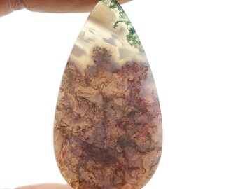 May include: A teardrop-shaped agate cabochon with a brown, white, and green dendritic pattern.