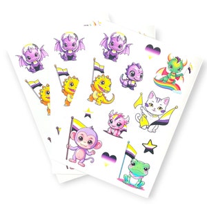Pode incluir: Um conjunto de três folhas de adesivos com vários animais de desenho animado, incluindo dragões, gatos, sapos e macacos. Cada animal está segurando uma bandeira do orgulho com listras amarelas, brancas e pretas. Os adesivos são perfeitos para adicionar um toque de personalidade a laptops, garrafas de água ou diários.
