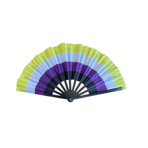 May include: A folding hand fan featuring horizontal stripes in yellow, white, purple, and black. The fan is constructed with a black frame and a pleated fabric canopy that displays these four distinct colours in a semi-circular arrangement.
